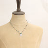 A mannequin wearing the knotted turquoise soar necklace
