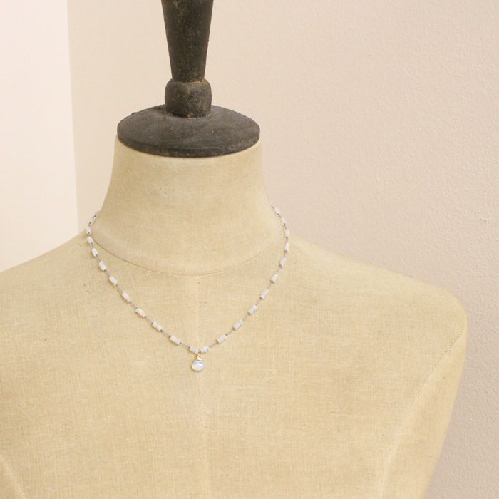 A mannequin wearing the knotted opal necklace