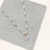 The knotted opal necklace styled on gray leather