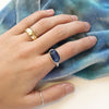 The kyanite ring being worn on a hand