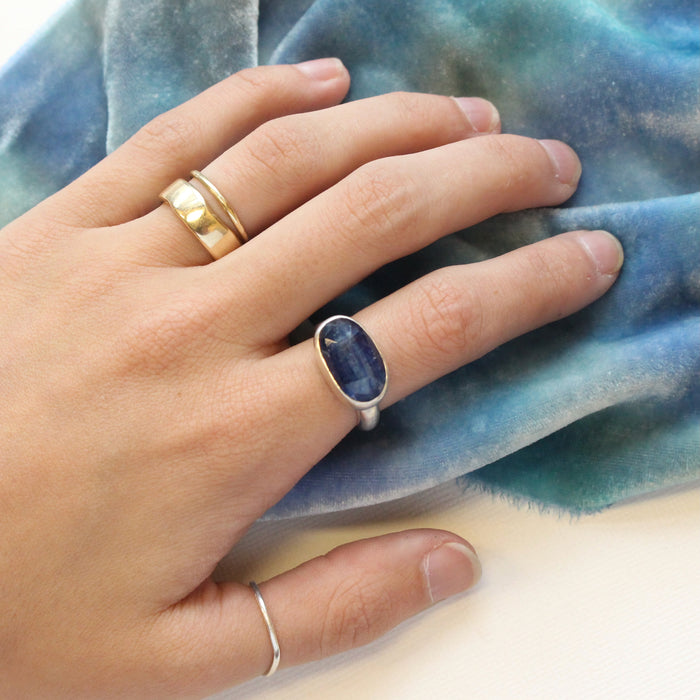 The kyanite ring being worn on a hand