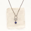 The lapis jolie necklace styled on tan linen