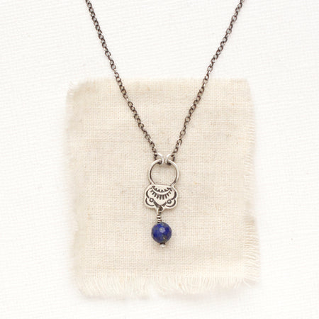 The lapis jolie necklace styled on tan linen