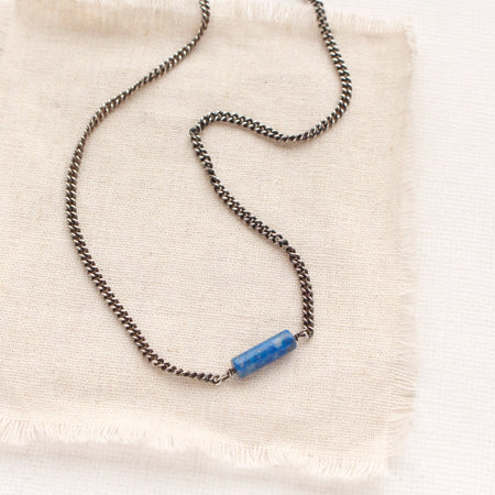 The sydney lapis necklace styled on tan linen