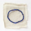 The lapis stretch bracelet styled on tan linen
