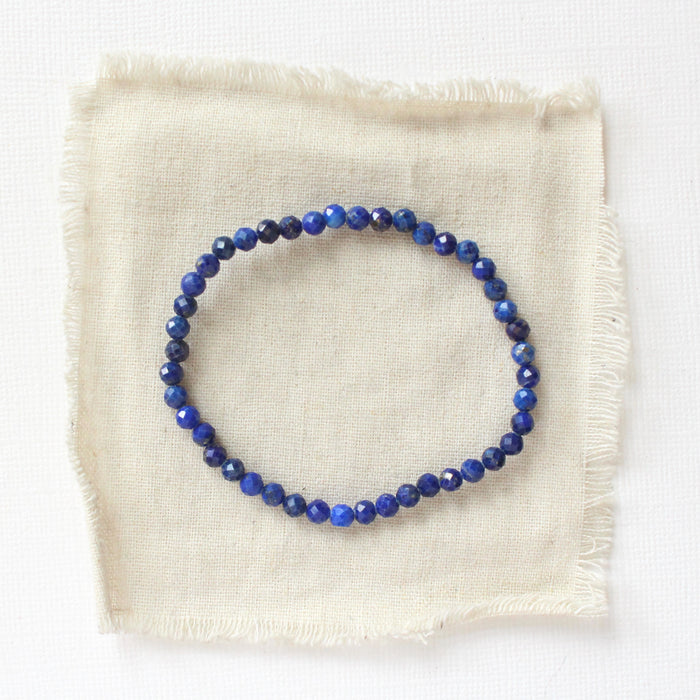 The lapis stretch bracelet styled on tan linen