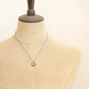 A mannequin wearing the bronze layered cactus flower necklace