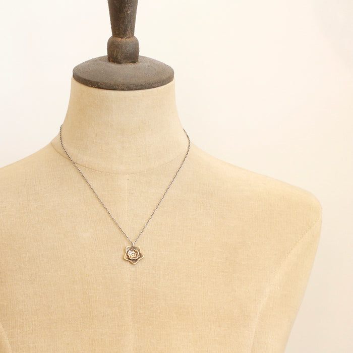 A mannequin wearing the bronze layered cactus flower necklace