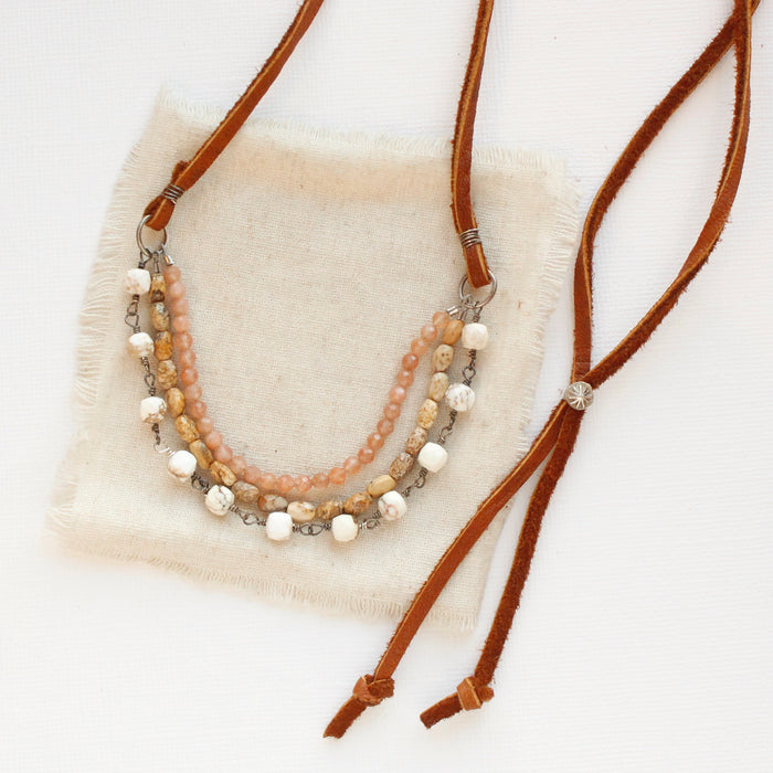 The layered desert adjustable leather necklace styled on tan linen