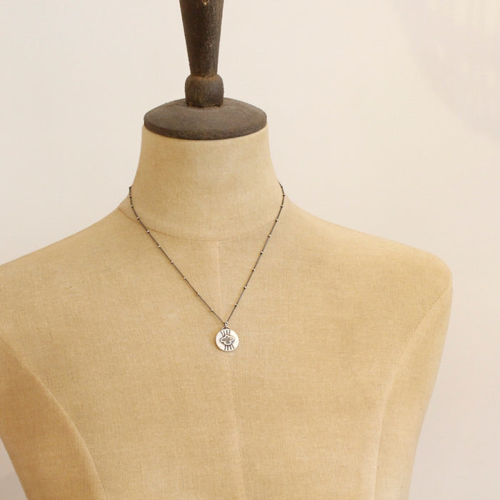 A mannequin wearing the layered soar necklace