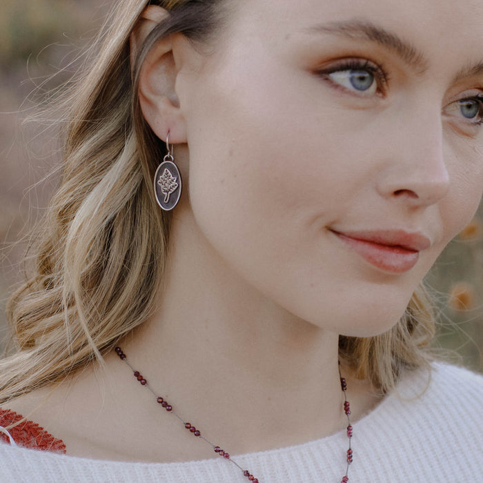 A model wearing the layered sprout earrings