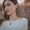 The layered sprout earrings on a model