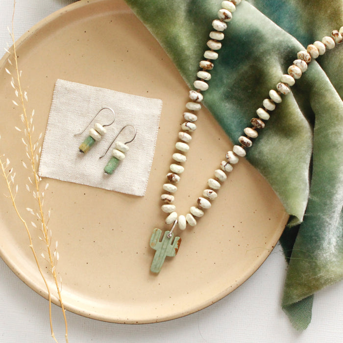 The turquoise and lemon chrysoprase lobe hugger earrings styled on a tan plate with the matching necklace 