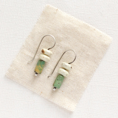 The turquoise and lemon chrysoprase lobe hugger earrings styled on tan linen