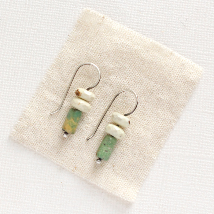 The turquoise and lemon chrysoprase lobe hugger earrings styled on tan linen
