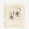 The little rustic rose earrings styled on tan linen
