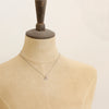 A mannequin wearing the mini soar necklace
