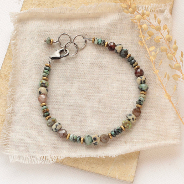 The lona bracelet styled on a tan rock with linen and dried grass