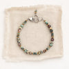 The lona bracelet styled on tan linen