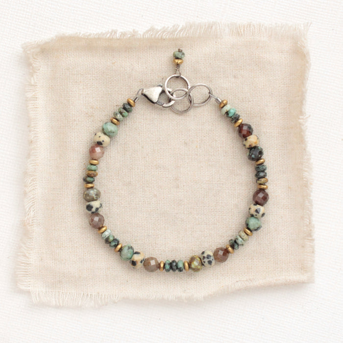 The lona bracelet styled on tan linen
