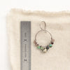 A lona hoop earring next to a ruler for size reference