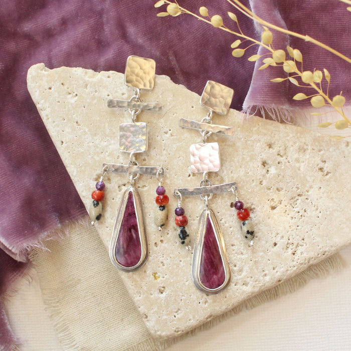 The maximalist purple spiny oyster post earrings styled on a tan rock with purple velvet and dried grass