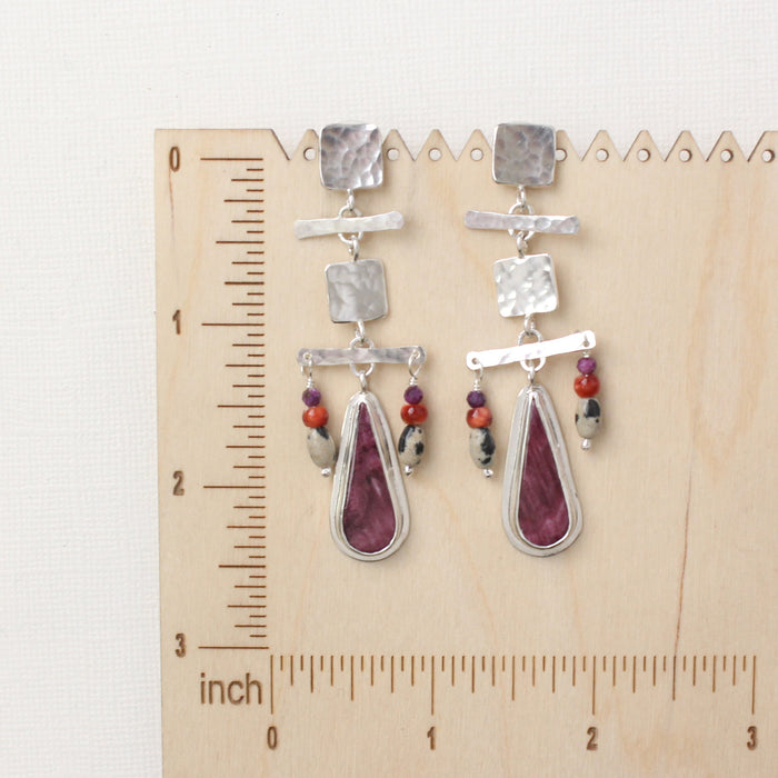 The maximalist purple spiny oyster post earrings on a wooden ruler for size reference