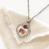 The sacred heart necklace styled on tan linen