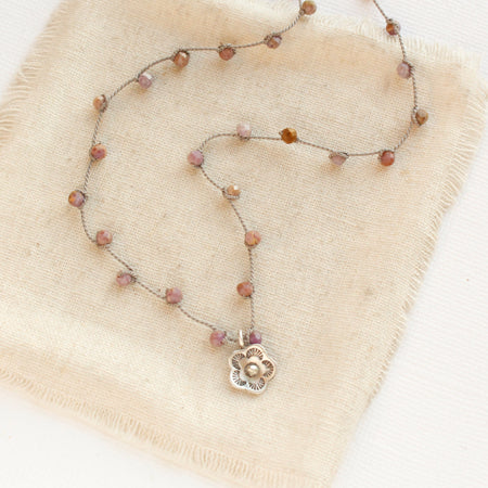 The mini cactus flower knotted phosphosidierite silk necklace styled on tan linen