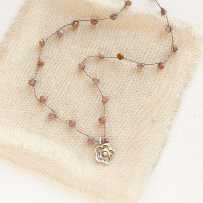 The mini cactus flower knotted phosphosidierite silk necklace styled on tan linen