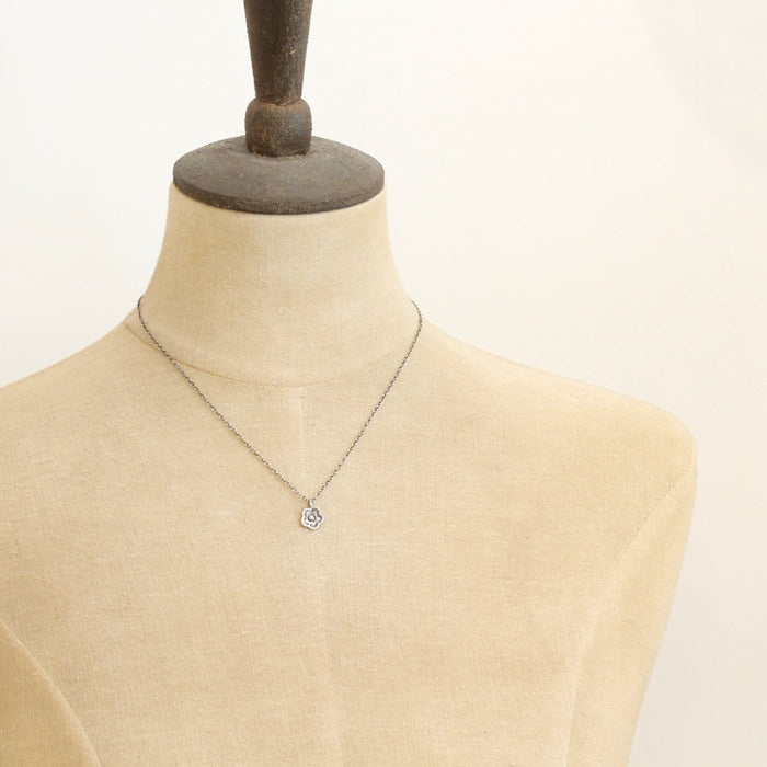 A mannequin wearing the mini cactus flower necklace