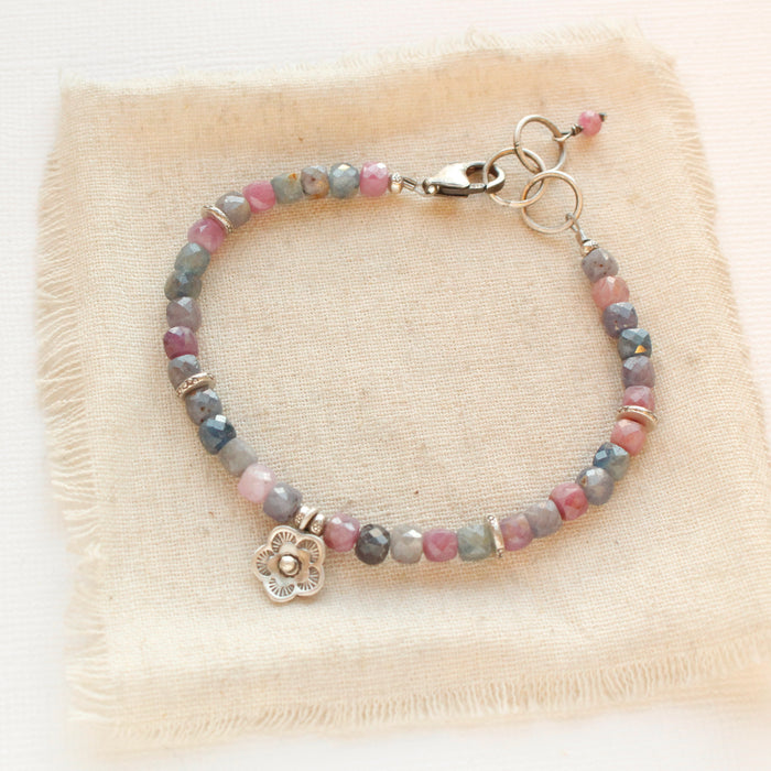 The mini cactus flower sapphire bracelet styled on tan linen