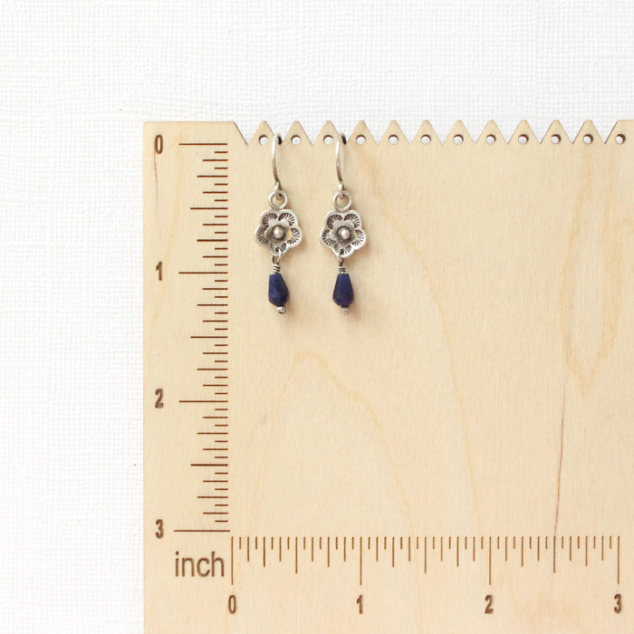 The mini cactus flower sodalite lantern earrings on a wooden ruler for size reference