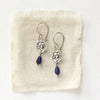 The mini cactus flower sodalite lantern earrings styled on tan linen