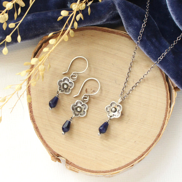 The mini cactus flower sodalite lantern set styled on wood with blue velvet and dried grass