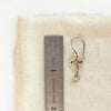 A mini soar turquoise earring next to a ruler for size reference