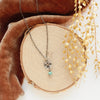 The mini soar and turquoise necklace styled on wood with orange velvet and dried grass