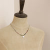 A mannequin wearing the knotted rainbow tourmaline mini sprout necklace