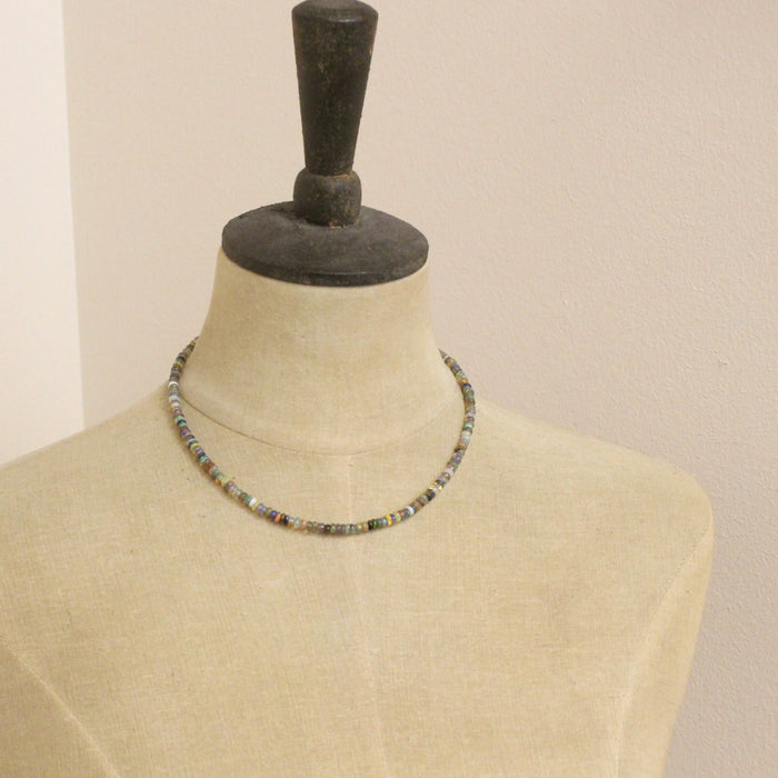 A mannequin wearing the mixed opal necklace