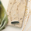The modern imperial jasper necklace styled on a tan rock with green velvet and dried grass