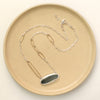 The modern imperial jasper necklace styled on a tan plate to show the adjustable lobster clasp closure