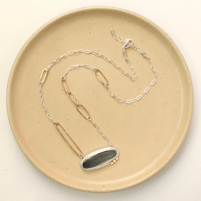 The modern imperial jasper necklace styled on a tan plate to show the adjustable lobster clasp closure