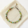 The monica bracelet styled on tan linen