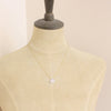A mannequin wearing the gold moonstone drop necklace