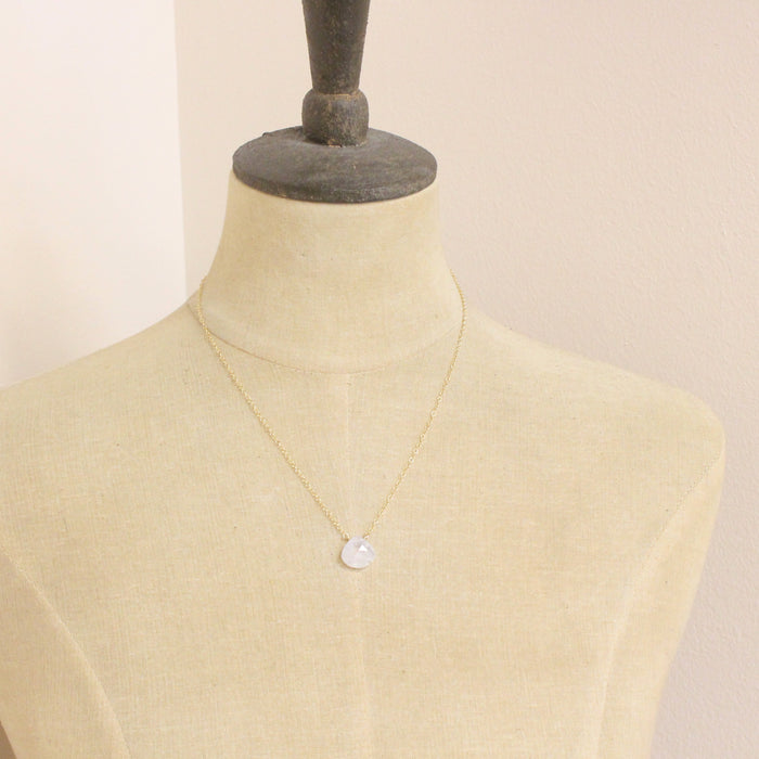 A mannequin wearing the gold moonstone drop necklace