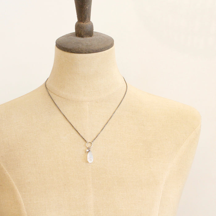 A mannequin wearing the moonstone and pearl necklace