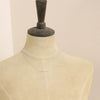 A mannequin wearing the opal bar necklace