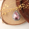 The organic thulite and little ruby ring styled on wood with orange velvet and dried grass