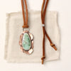 The organic variscite leather necklace styled on tan linen