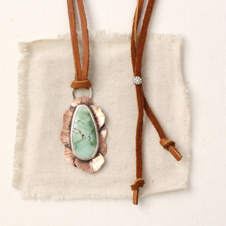 The organic variscite leather necklace styled on tan linen